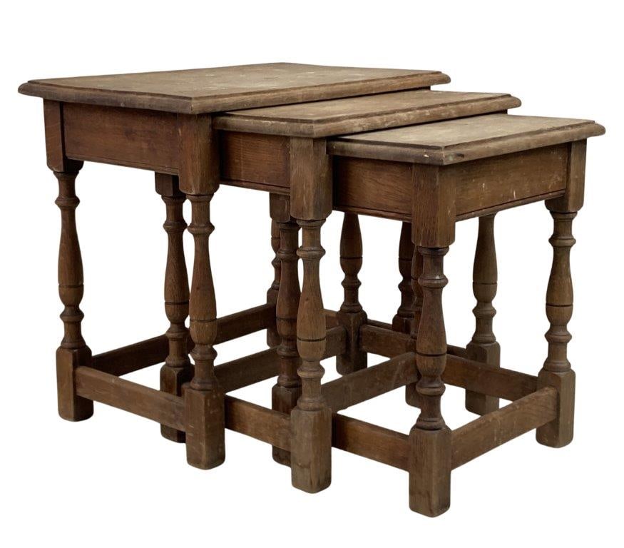 English Oak Nesting Tables: A set of English oak nesting tables with a warm finish and finely turned legs. The largest table measures approximately 18″ H x 19 1/2″ W x 12″ D. In good condition with light wear