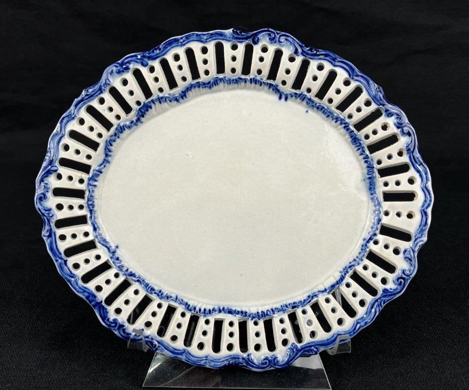 Small Staffordshire Pearlware Decorated and Pierced Plate: An early 19th century Staffordshire pearlware plate, circa 1810, decorated in cobalt blue with a reticulated pierced edge. Measures approximately 3/8″ H x 7″ W x 6″ D. In good condit