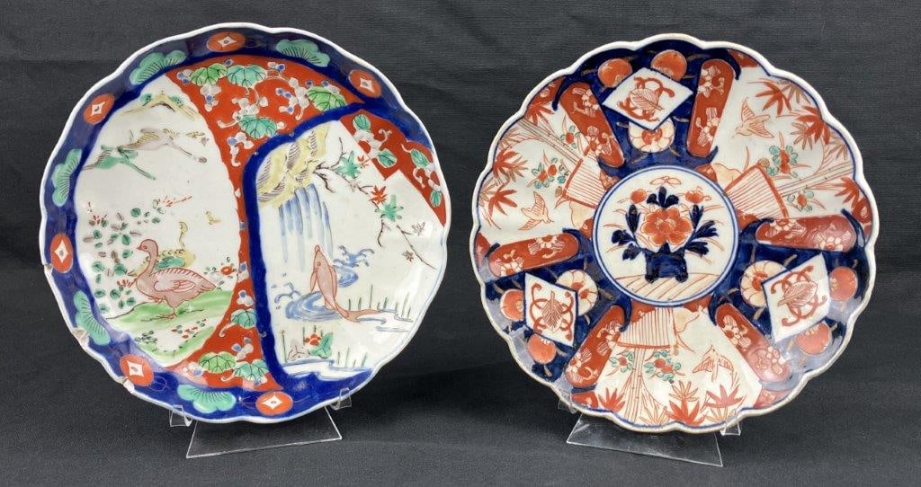 Two Imari Plates: A pair of Japanese Imari porcelain plates decorated in characteristic red, blue, and green tones. One features a bird and fish motif, while the other depicts a traditional basket of flowers. One