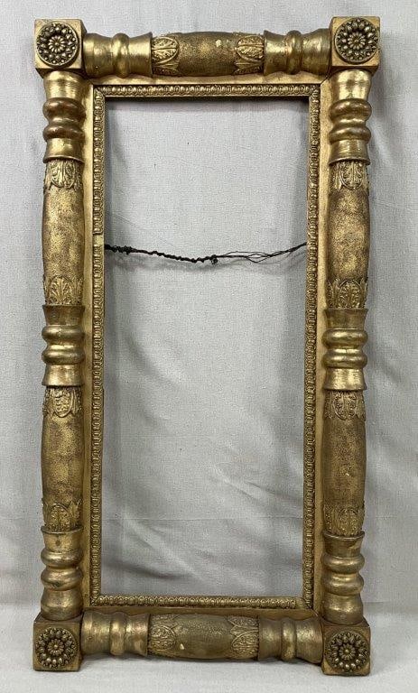 Gilt Classical Motif Frame: A large antique gilt frame of robust proportions featuring classical architectural elements including acanthus leaves, scrolling ornament, and curving columnar forms. The richly detailed surface and