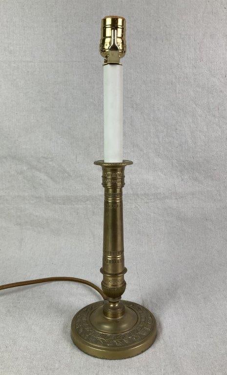 Vintage Brass Candlestick Lamp: A vintage brass candlestick-form table lamp with a gold-tone finish, featuring classical relief decoration along the column and a leaf-and-fruit motif on the round base. Measures approximately 16