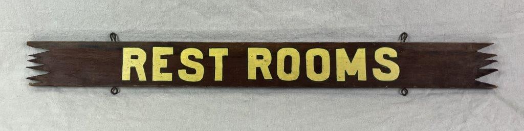 Hand Painted Restrooms Sign: An antique wood sign featuring hand painted lettering identifying it as a “Restrooms” sign, the surface retaining a rich, timeworn patina that enhances its authentic character. The