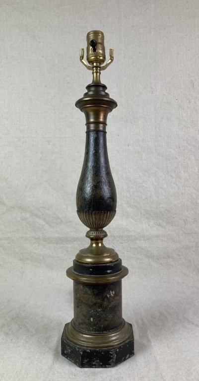 19th Century French Tole Lamp: A 19th century French tôle peinte table lamp featuring an urn-shaped body with brass accents. Decorated with painted floral and bird motifs around the body and base, and set on an octagonal
