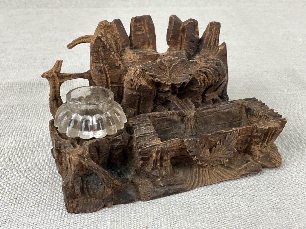 Folk Art Carved Inkwell: A carved wooden inkwell in a style characteristic of Black Forest design, possibly dating to the late 19th century. Decorated with naturalistic leaf and forest motifs in relief. Measures approximately