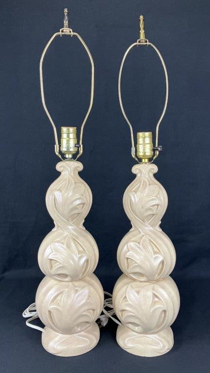 Mid Century Modern Ceramic Holland Mold Lamp Pair: A pair of Mid Century Modern ceramic lamps produced from Holland Mold forms, featuring ivory to cream speckled glazes with dynamic swirling relief decoration. The sculptural cylindrical bodies offer