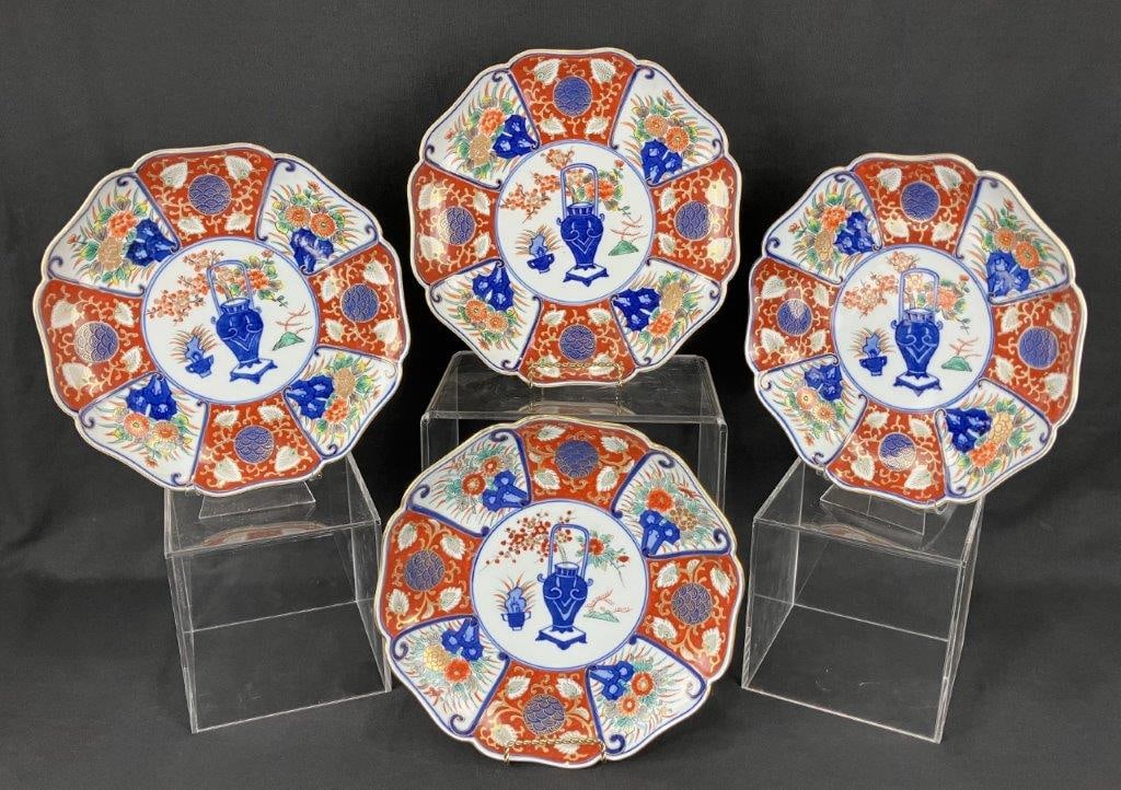 Four Imari Plates: A set of four elegant Japanese Imari plates, decorated in rich reds, blues, greens, and gold with characteristic matching designs. One plate measures approximately 1 1/4″ H x 10″ in