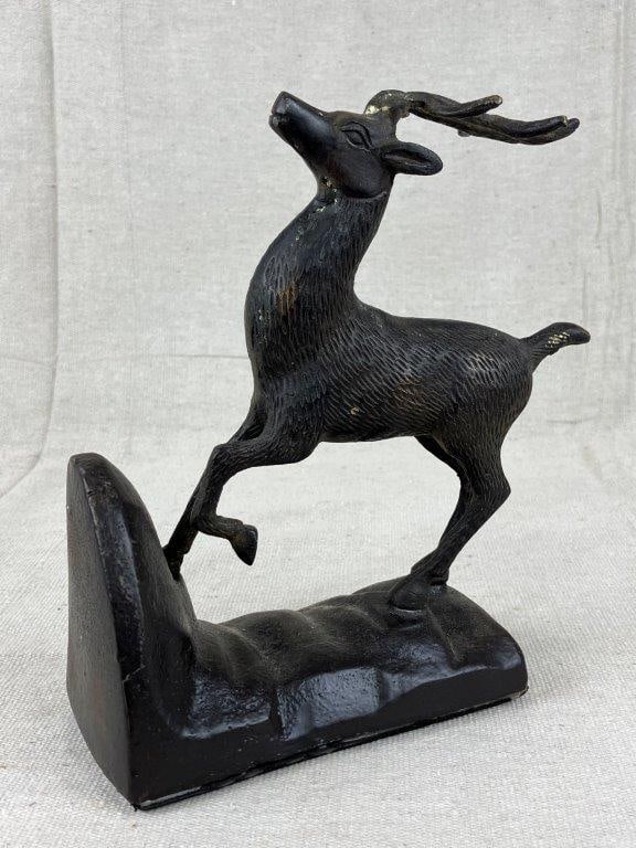 Cast Iron Stag Sculpture: A cast iron stag sculpture, possibly intended for use as a doorstop or bookend, modeled with precise incised linework defining the form of the deer. Measures approximately 8 1/2″ H x 7″ W