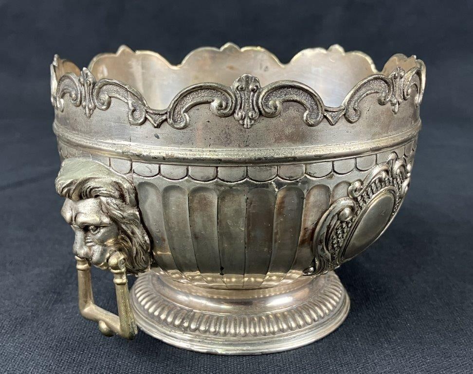 Silver-Plated Monteith Bowl: A 20th century silverplate Monteith bowl by Corbell & Company, featuring a scrollwork scalloped rim and lion head handles. Bears the company’s distinctive hallmark. Measures approximately 3