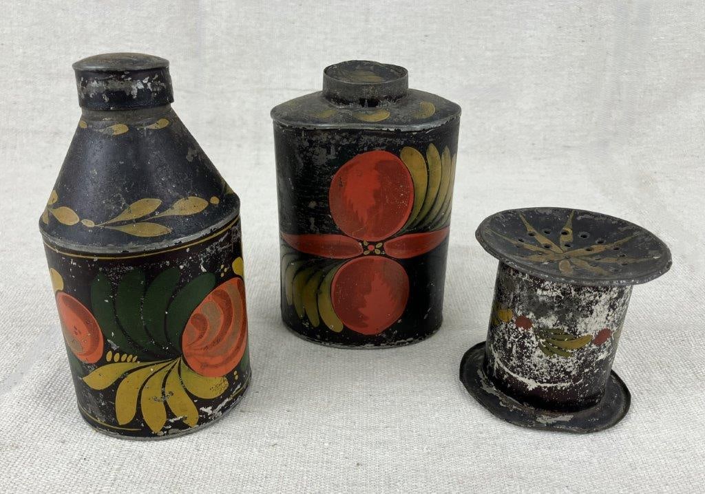 Three Toleware Storage Vessels: A group of three toleware storage vessels, each finished in classic black paint and decorated with hand-painted floral designs reflecting folk artistry. One vessel measures approximately 5 1/8″