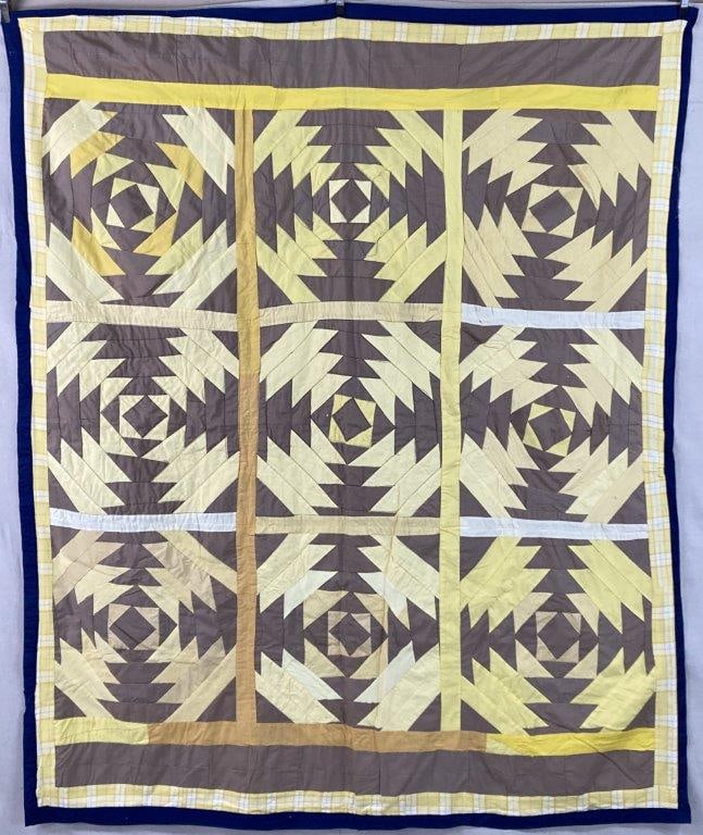 Pineapple Pattern Quilt: A quilt in the traditional Pineapple pattern rendered in rich yellow tones accented by soft neutrals, creating a warm and inviting palette. The radiating geometric blocks form a visually dynamic yet