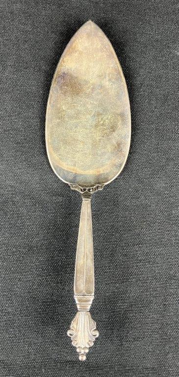 Georg Jensen Sterling Silver Pie Server: A sterling silver pie server by notable Danish maker Georg Jensen, featuring a classic, elegant form. Marked for sterling silver content. Weighs approximately 74.48 grams. Measures approximately 8