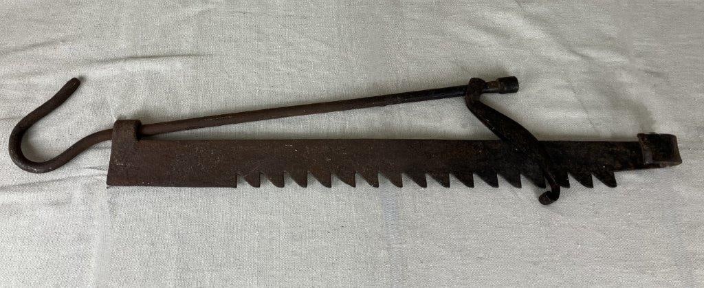 Wrought Iron Fireplace Trammel: A sturdy wrought iron fireplace trammel of traditional antique form, hand forged and accented with solid construction. The elongated adjustable design reflects its historical utility while offering st