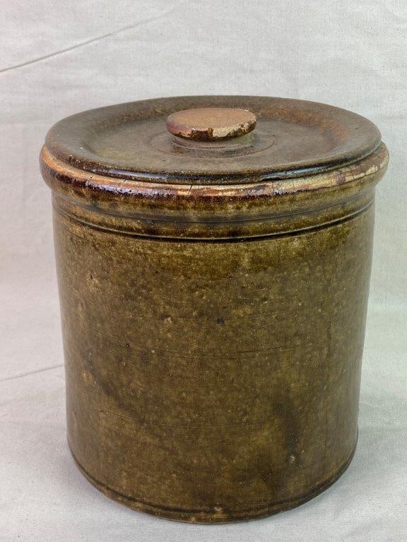 Southern Alkaline Glaze Stoneware Crock: A covered Southern stoneware crock with a traditional straight-sided cylindrical form, finished in an alkaline glaze. Measures approximately 9 3/4â€³ H x 9â€³ in diamet
