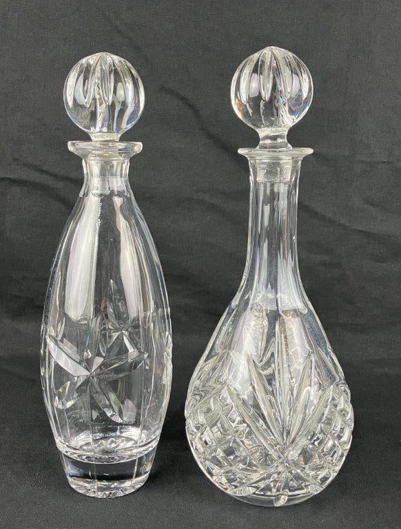 Pair of Crystal Decanters: A pair of crystal decanters, including one example by Towle. The larger decanter measures approximately 13â€³ H x 5â€³ in diameter. The larger example shows an