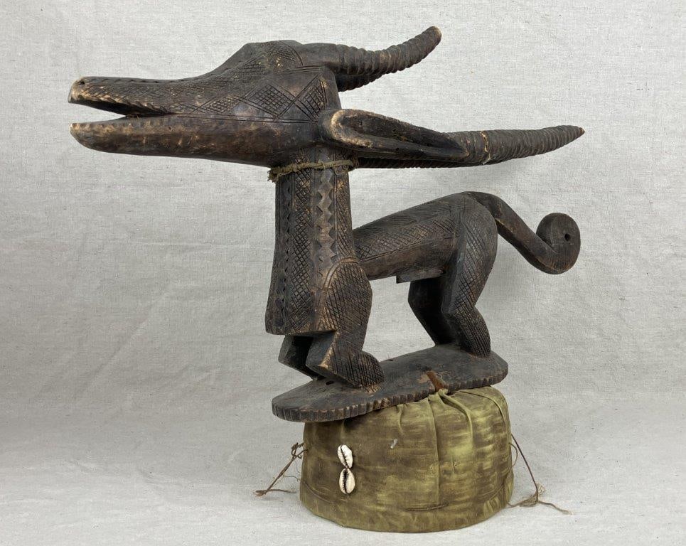 Bamana Chi Wara Antelope Headdress: A carved wooden Chiwara antelope headdress created by the Bamana people of Mali, traditionally worn as a head crest in ritual dances celebrating agriculture. Depicts an antelope with four horns and