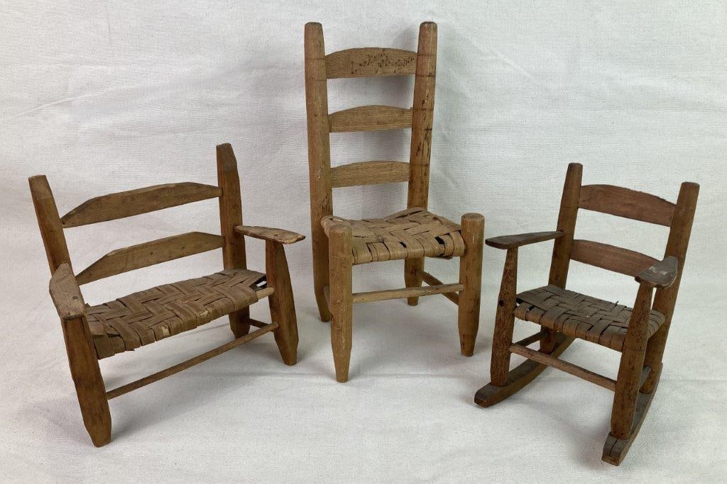 Three Small Country Chairs: A group of three small country chairs, including one rocking chair, one chair bearing the mark of Lookout Mountain, and one bench. Each displays a sturdy, robust, and well-constructed form. The