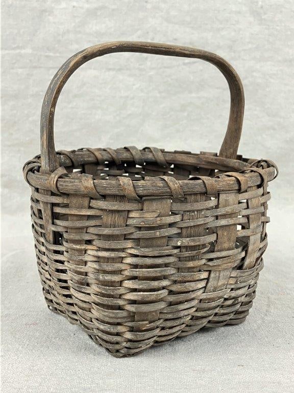 Small Gathering Basket: A nicely woven small gathering basket with a wrapped rim and a worn, aged patina. Measures approximately 6 3/4â€³ H x 6â€³ W x 5 1/4â€³ D. Shows some
