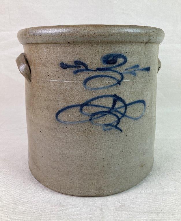 Stoneware Crock: A salt-glazed stoneware crock featuring a cobalt blue â€œbee stingâ€ decoration and applied lug handles. Retains a worn, aged patina from use. Measures approximately 1