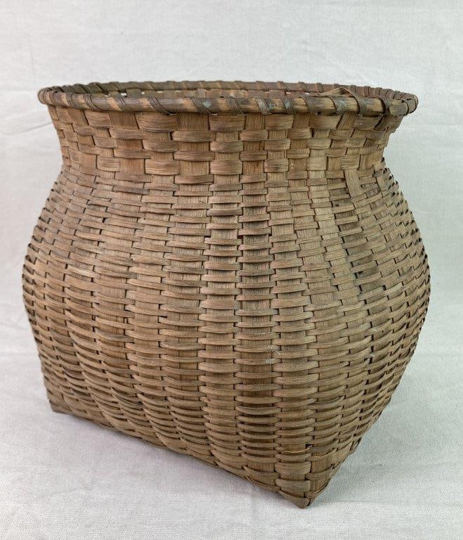 Native American Barrel Basket: A finely woven split oak Native American basket with a pot-bellied barrel form and wrapped rim. Displays a worn, mellowed patina from use. Measures approximately 11 3/4â€³ H x 12