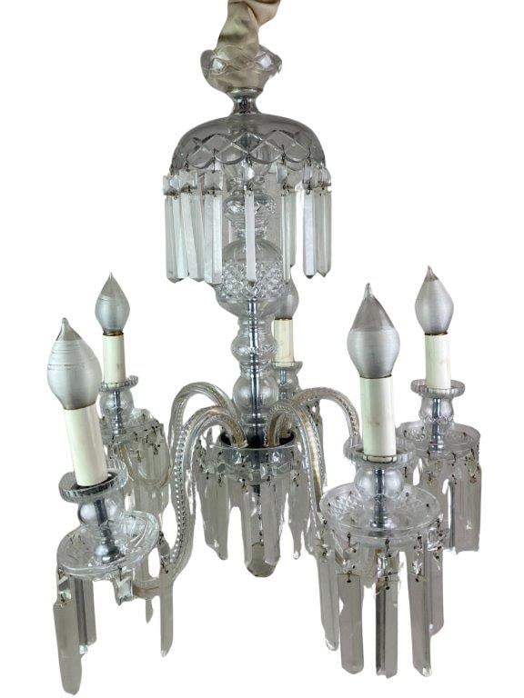 Empire Cut Crystal Chandelier: An Empire-style cut crystal chandelier featuring a classic urn-form central column with five scrolling arms and candle-style sockets, adorned with hanging prisms. Measures approximately 26″ H x