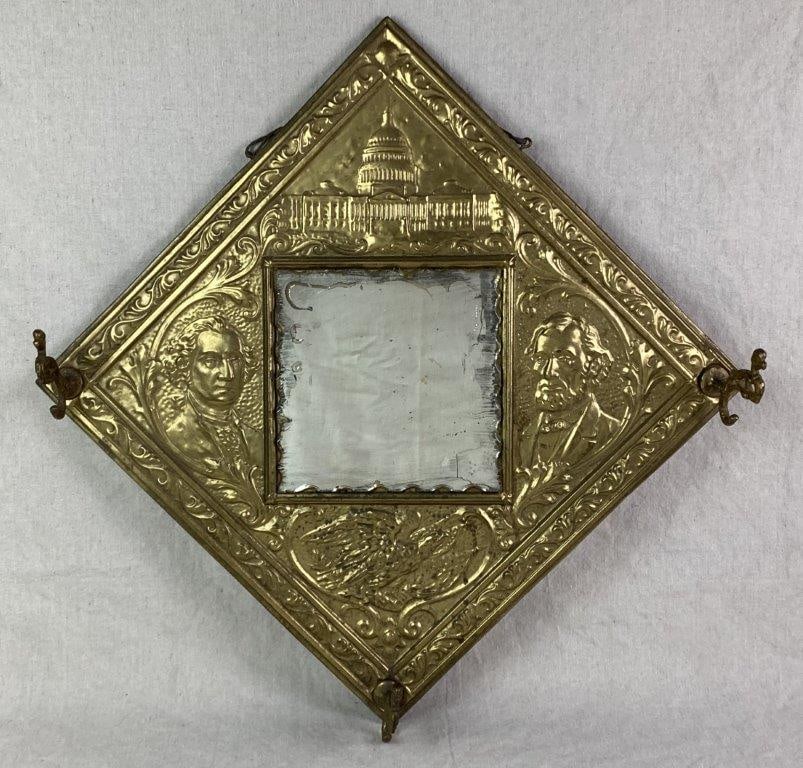 Presidents Tin Mirror: A vintage diamond-shaped tin mirror with embossed portraits of George Washington and Abraham Lincoln, an embossed image of the United States Capitol at the top, and an embossed eagle with American