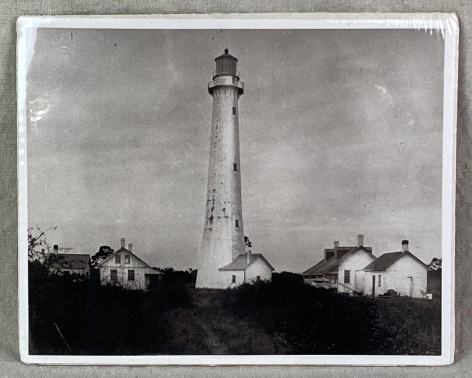 Photograph of Tybee Island Lighthouse: A hand-printed black-and-white photograph depicting the Tybee Island Lighthouse in Georgia. Measures approximately 8″ H x 10″ W. In good condition. 