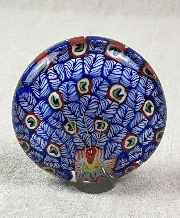 Murano Millefiori Peacock Paperweight: An attributed Murano glass millefiori paperweight featuring a peacock motif rendered in vibrant, traditional colors. Retains the original maker’s label to the underside. Measures approximately
