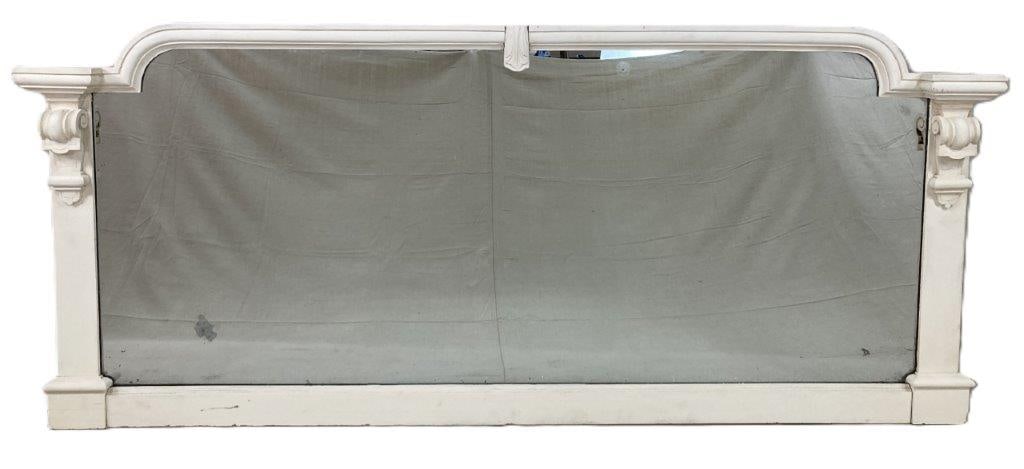 White Painted Architectural Mirror: A substantial white painted architectural style mirror, richly decorated with applied molding and ornate corbel forms, lending depth and classical presence. Well suited for display above a sideboard