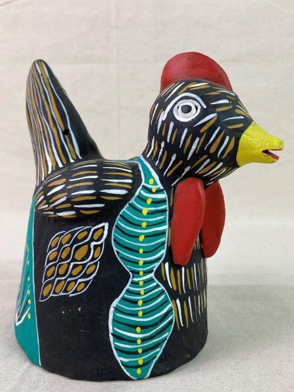 Mexican Folk Art Clay Chicken Sculpture: A hand-crafted folk art clay chicken sculpture, hand-painted with a black ground accented in red, yellow, and teal. Displays a lively, expressive surface with artisanal character. Measures