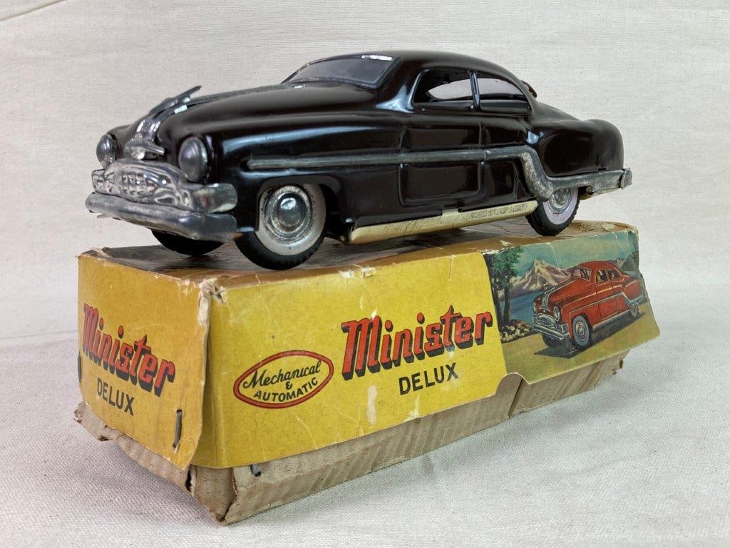 Vintage Minister Deluxe Tin Toy Car: A dark brown friction-powered tin toy car produced by Amar Toys in Delhi, India. Accompanied by its original box. Exhibits a worn, aged patina consistent with play and handling. The box measures appro