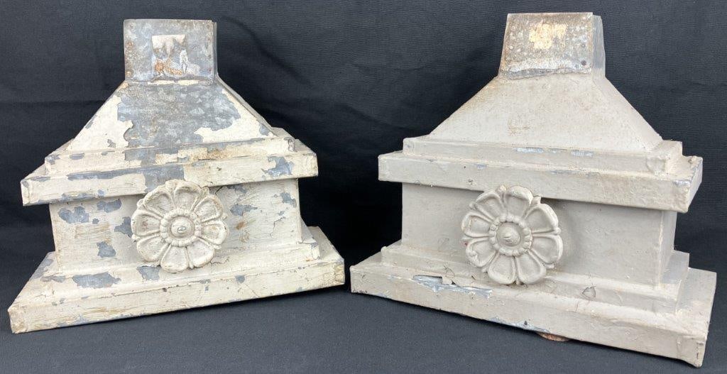 Decorative Floral Architectural Elements: A group of decorative floral architectural elements, likely downspout components, finished with neutral paint over metal forms. Displays sculptural detailing throughout. One element measures