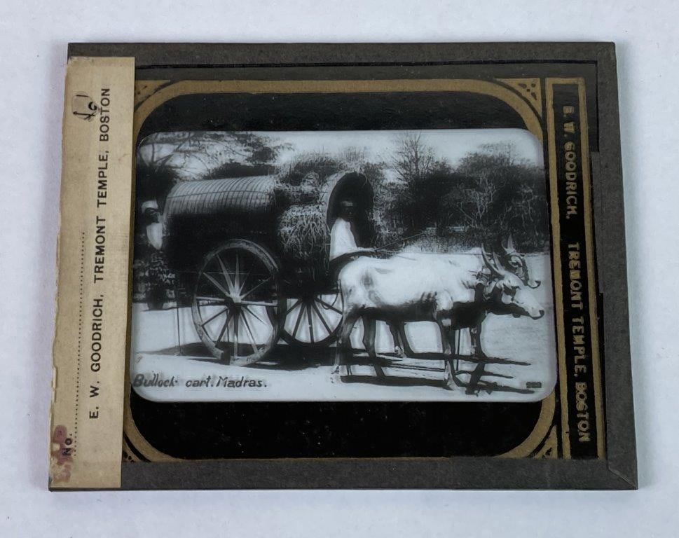 Late 19th Century Magic Lantern Slide of Indian Man and Ox-Drawn Cart: A late 19th century magic lantern slide produced by E. W. Goodrich of Tremont Temple, Boston. Depicts an Indian man riding in a covered wagon pulled by two oxen, labeled “Bullock Cart.