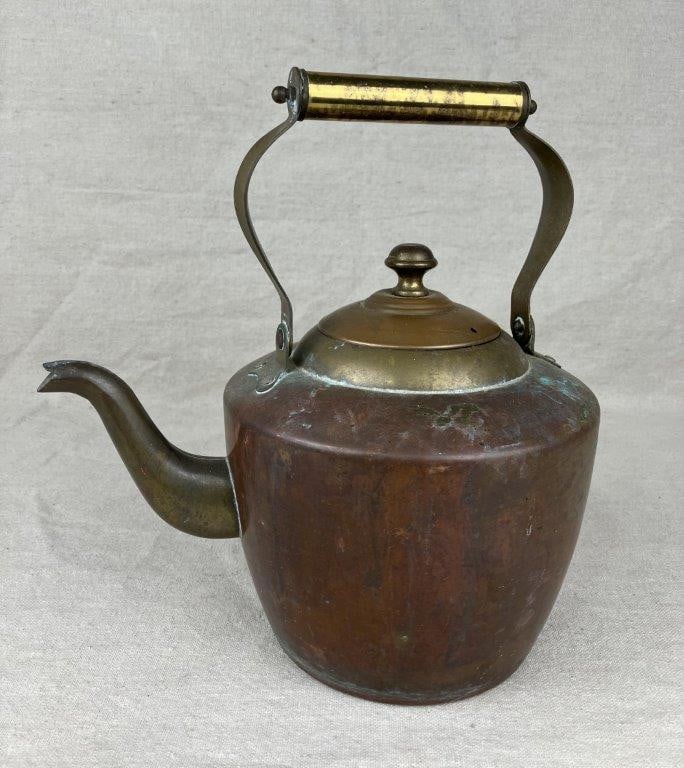Copper and Brass Teapot: An antique copper and brass teapot in a traditional form, featuring a gooseneck spout. Measures approximately 7 3/8â€³ H x 9â€³ W x 7â€³ D with the hand