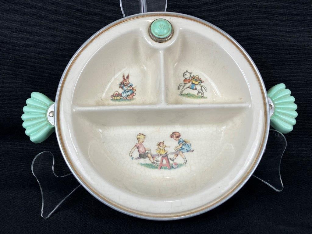 Vintage Porcelain Child's Hot Water Warmer: A vintage porcelain child’s hot water warmer by the Majestic Company, printed with charming children’s illustrations. Measures approximately 2 1/4″ H x 11″ W x 8 1/8″ in