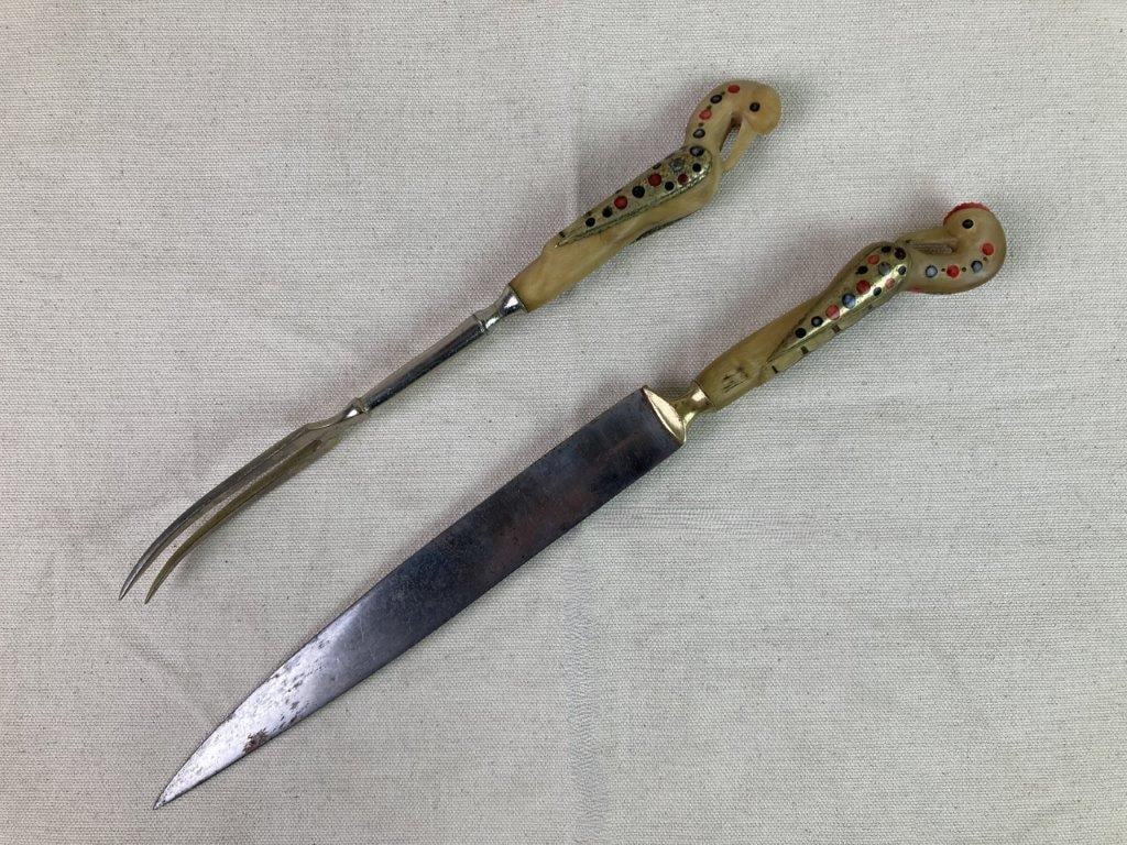 Vintage Jezzine Ware Carving Knife and Fork: A vintage carving knife and fork by Jezzine Ware, featuring hand-crafted bone handles with inlaid dyed bone details, each handle carved in the form of a bird’s head. The knife has a stainless