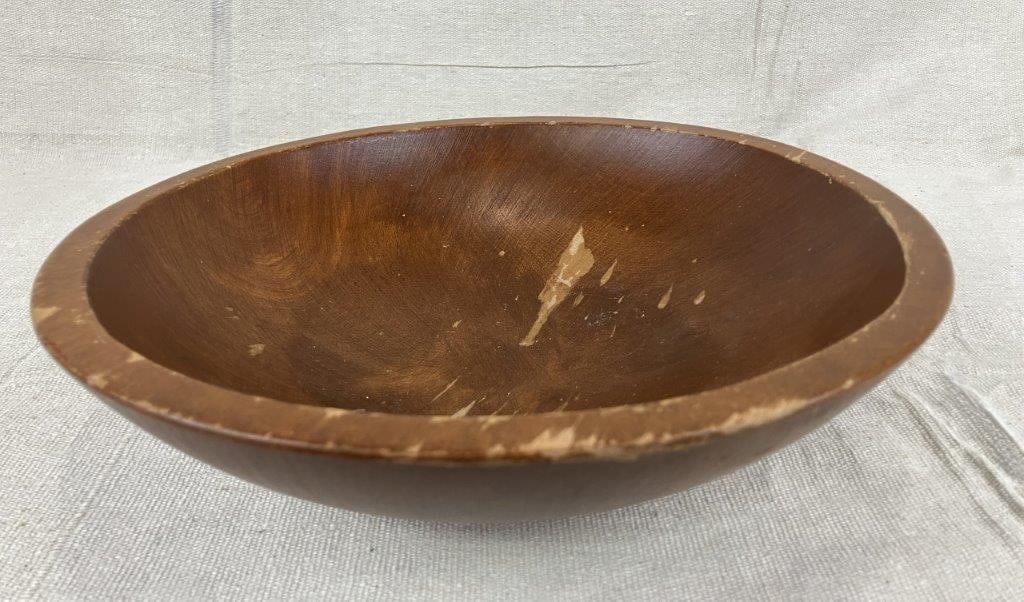 Turned Dough Bowl: A turned wooden dough bowl in a traditional form, exhibiting a rich, mellowed patina developed through use. Measures approximately 3 1/8″ H x 11 1/8″ in diameter. Shows surface wear with
