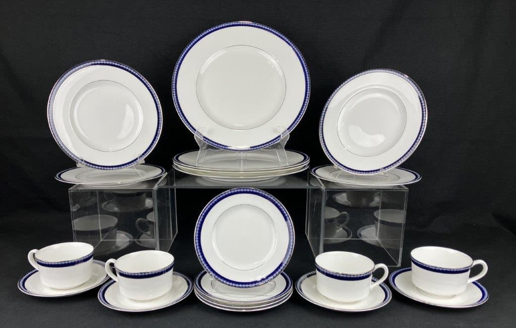 Twenty Pieces of Royal Worcester China: A 20-piece set of fine china by Royal Worcester, dated 1968 copyright. Decorated with a silver edge and cobalt-toned accents in a refined, classic pattern. The set includes four saucers, four