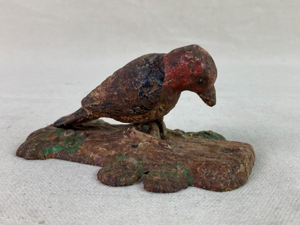 Vintage Cast Iron Woodpecker Door Knocker: A cast iron painted door knocker designed as a red-headed woodpecker, with an articulated form that simulates pecking against a tree. Retains a worn, aged patina to the surface and paint. Measures app