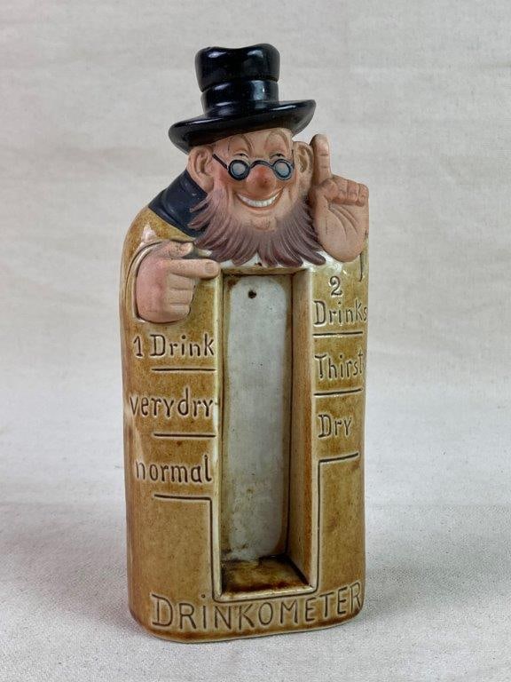 Vintage SchÃ¤fer & Vater Porcelain Drinkometer: A whimsical figural porcelain flask by Schafer & Vater, modeled as a standing man and designed to humorously indicate a personâ€™s level of â€œdryness.â€