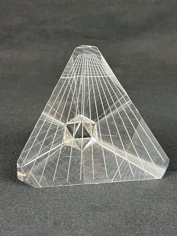 Steuben Art Glass Tetrahedron Paperweight: A prismatic glass tetrahedron paperweight designed by Peter Yenawine for Steuben Glass Works, formed as a pyramid with a central geometric element suspended within. Measures approximately 3