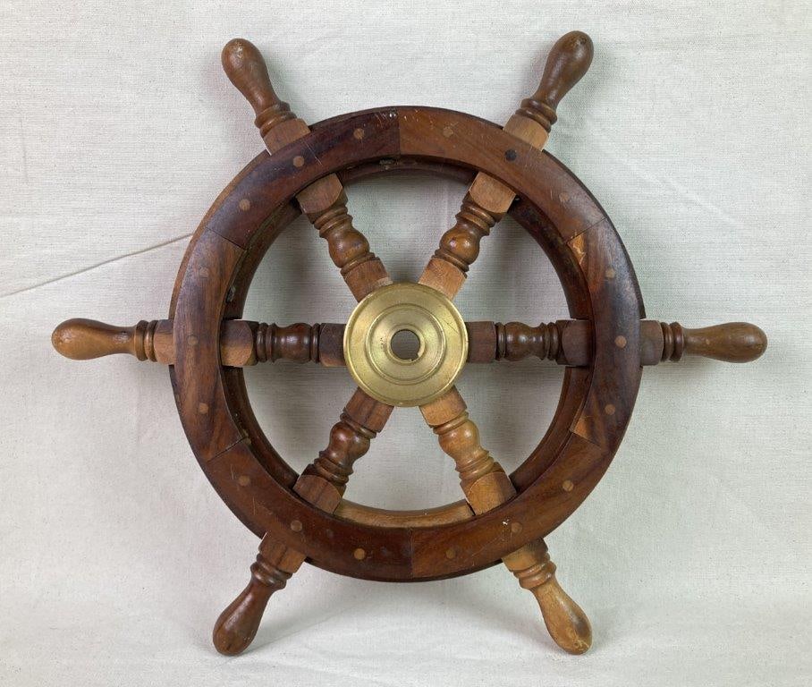 Wood and Brass Ship Wheel: A decorative shipâ€™s wheel featuring six turned wooden spokes and a brass center hub, showcasing a warm, attractive wood selection. Measures approximately 18 3/8â€³