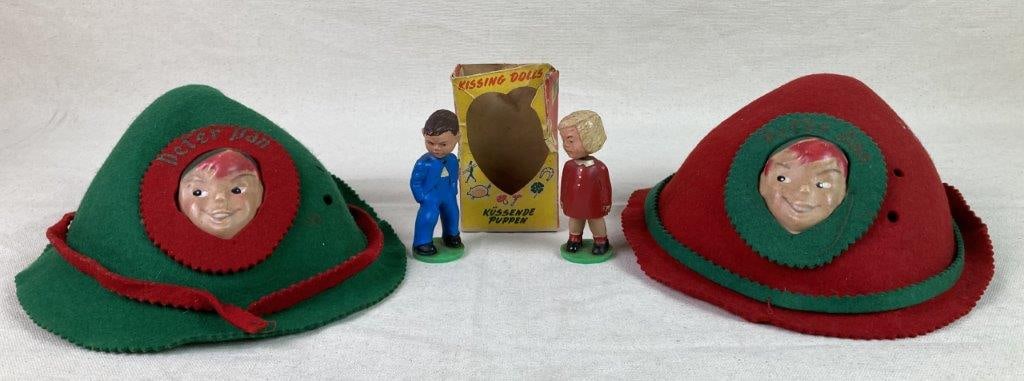 Vintage Walt Disney Peter Pan Felt Hats and Magnetic Kissing Dolls: A vintage grouping of mid-century novelty items, including two Walt Disney Peter Pan souvenir hats sold at Disneyland in the 1960s. The hats are crafted of wool felt, each with a celluloid Peter Pan