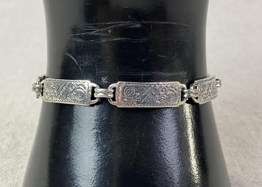 Southwestern Sterling Silver Bracelet: Sterling silver bracelet composed of linked panels featuring decorative Southwestern motifs in a classic articulated form. Marked 925 for silver content. Measures approx. 6" L. Total weight approx.