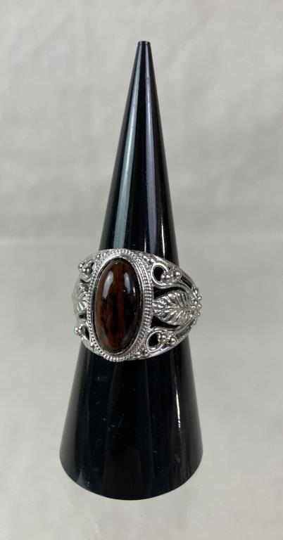 Karis Silvertone and Ironstone Statement Ring: Karis brand statement ring in silvertone metal featuring pierced leafy filigree decoration and a central oval cabochon in an ironstone tone. Ring size approx. 7. In good condition 