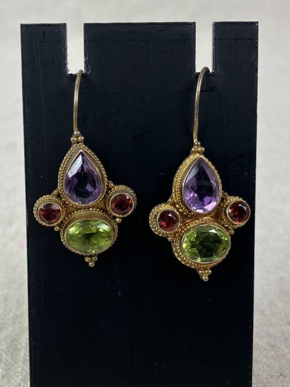 Renaissance Revival Style Sterling Silver and Gold Vermeil Earrings: Vintage Renaissance Revival style drop earrings featuring a grouped arrangement of faceted peridot, amethyst, and garnet, framed within sterling silver mounts accented with rich gold vermeil in a