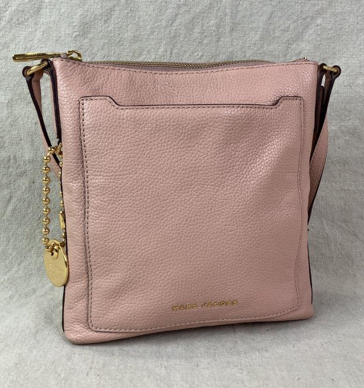 Marc Jacobs Tourist Crossbody Bag: Rose pink pebbled leather crossbody bag by Marc Jacobs, featuring gold-tone hardware, zip-top closure, and an adjustable leather shoulder strap. Designed with a front exterior slip pocket accented by