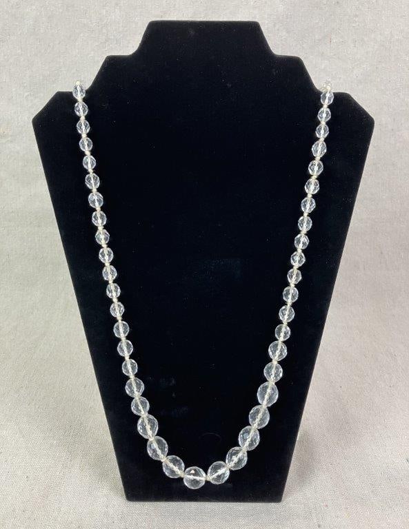 Vintage Givenchy Crystal Necklace: Cut clear crystal bead necklace composed of faceted beads with a silver-tone clasp designed in the style of interlocking letter G forms set with clear gemstones, stamped Givenchy 1977 to the clasp.