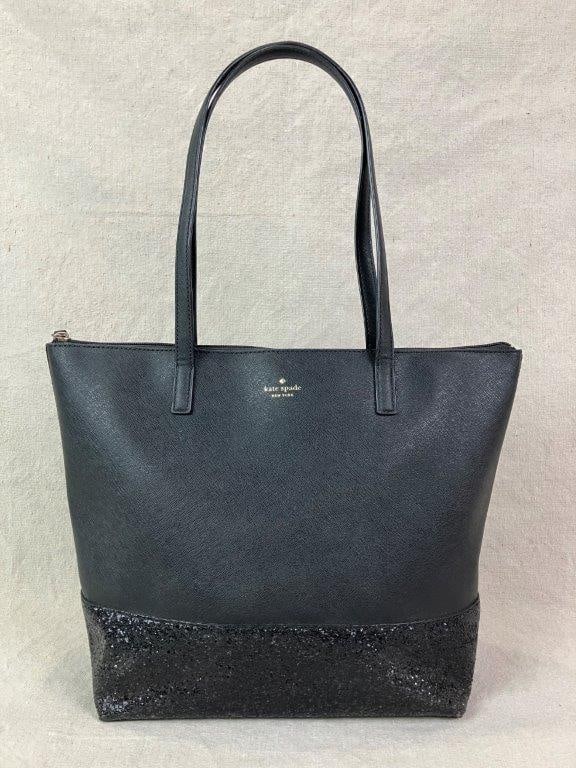 Kate Spade New York Black Glitter Court Penny Tote Bag: Elegant Court Penny tote by Kate Spade New York crafted in black crossgrain vinyl, featuring a glitter-adorned base panel and signature goldtone Kate Spade New York logo to the front. Structured