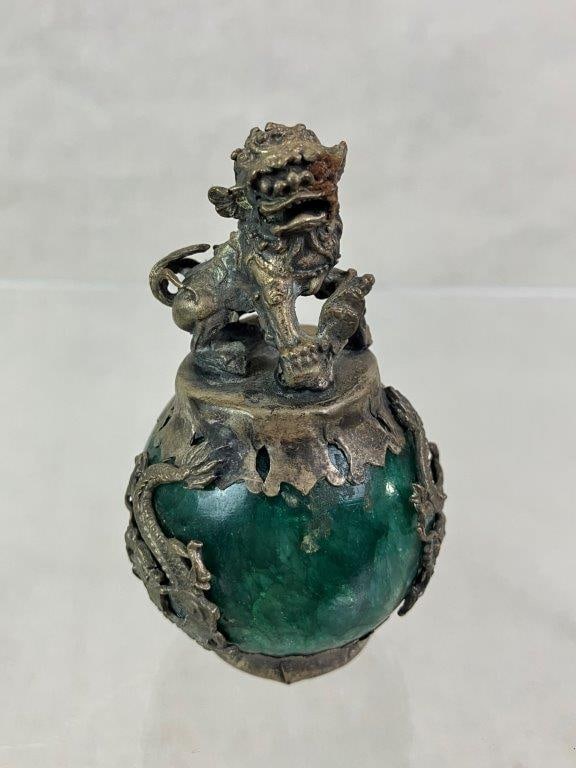 Sterling Silver Chinese Foo Dog and Dragon Nephrite Jade Sculpture: Sculptural piece featuring a polished spherical nephrite jade stone secured within a sterling silver mount, surmounted by a sculptural Foo Dog and flanked by dragons grasping the stone. Unmarked but