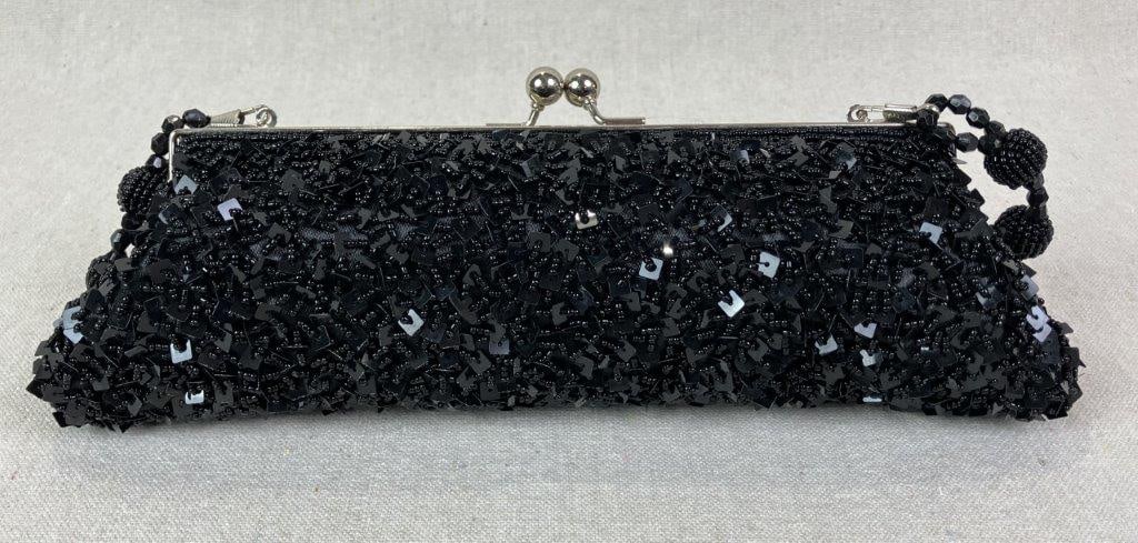 Cadari London Beaded and Sequin Black Evening Bag: Elegant, elongated evening bag by Cadari London, adorned with black beads and sequins and finished with a complementary beaded strap. Features a black satin interior with maker's emblem and a silver